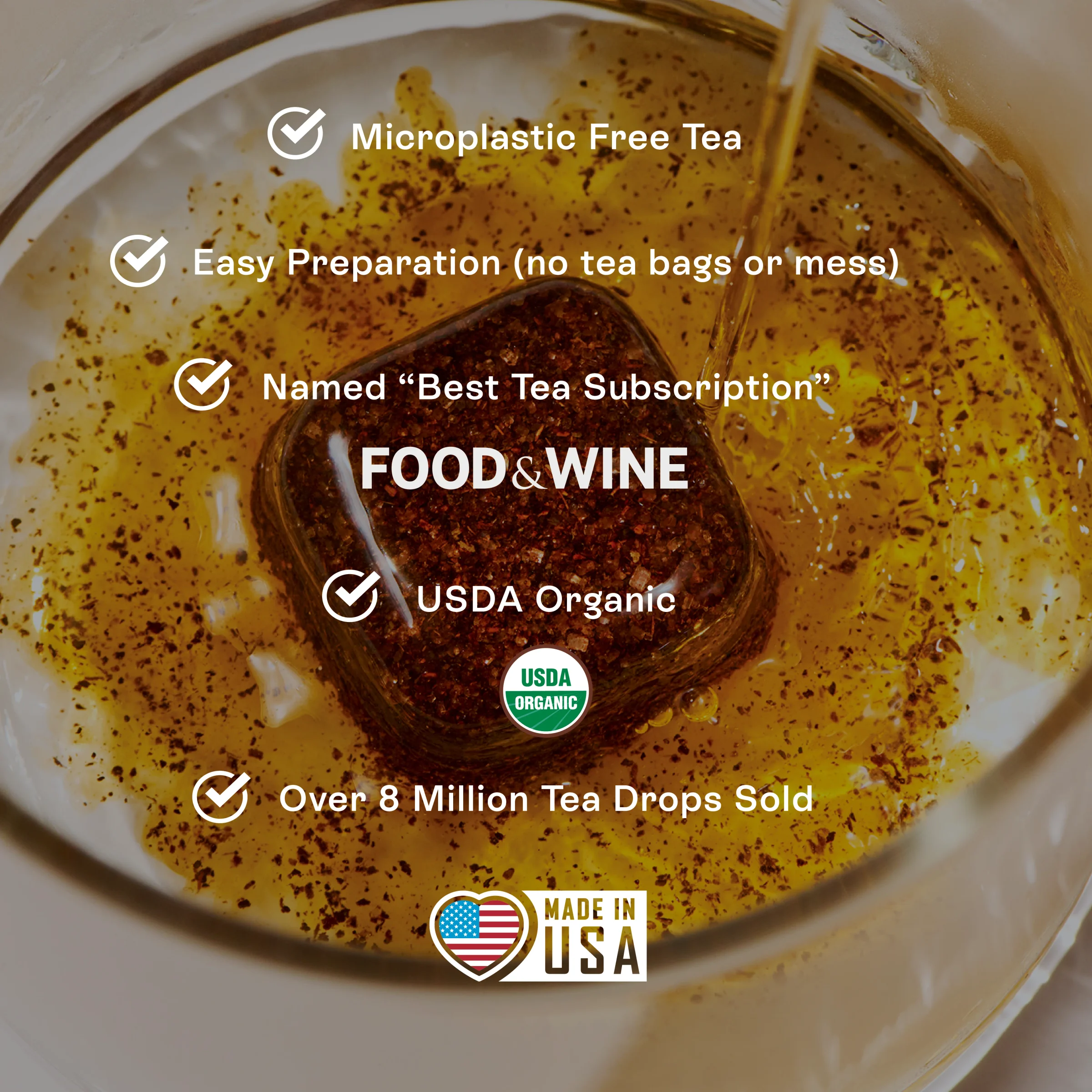 A Tea Drop dissolving in amber tea, with badges for easy preparation, USDA Organic and made in the USA